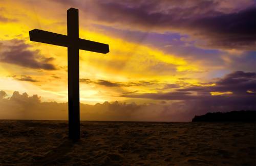 christian cross on sunset background