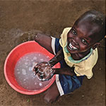 boy with hands and bucket of water